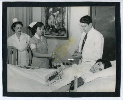 Student nurses and doctor with a patient.
