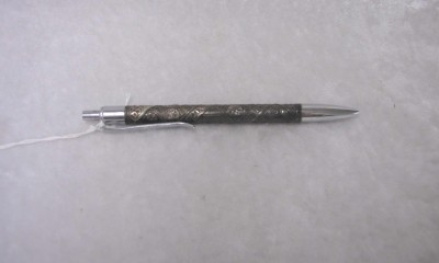 Sterling silver pen, with push button end for retractable ball point, central portion of cylinder engraved in a decorative design representing the Tribes of Israel, front portion unscrews to change ink refill.  Courtesy of William Saxon, Jr.  1994.78.2