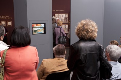 Visitors crowd around the TV cabinet at the opening of Nancy Patz: Her Inward Eye  in April 2010.
