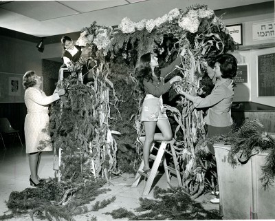 2006.013.1062 – In this photo from 1974 women decorate a sukkah at the JCC. Looking for creative decorating ideas – check out these fun project ideas: pinterest.com/kosheronabudget/sukkah-decorating-ideas/