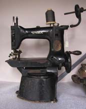 1997.149.003  Button sewing machine (1930s), made by Singer, from D. Schwartz and Sons Garment Machinery Co., of Baltimore Street and later, Gay Street.