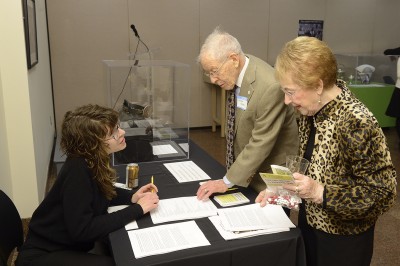 Researcher Alicia Puglionesi collects stories from attendees.