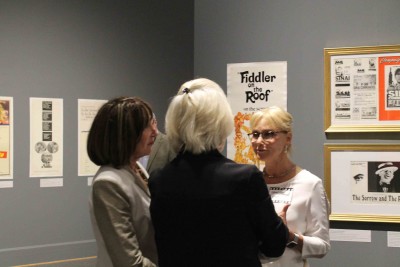 Visitors have a conversation about the film posters in the exhibit.  