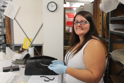 Collections Intern Kaleigh inventories a doctor's bag.