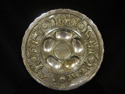 Bezalel style seder plate, silver plated brass with scalloped edge, purchased from Rabbi Benjamin Dinovitz of Ohel Yaakov Synagogue, c. 1930. JMM 1994.197.001