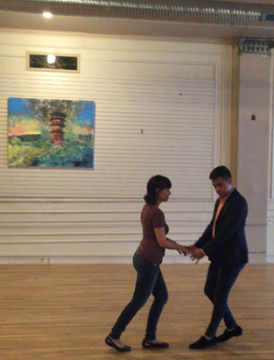 The salsa instructor demonstrates a move with one of my peers.
