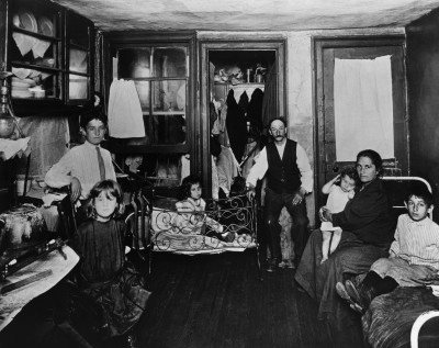 A picture taken by Jacob Riis depicting the difficult living conditions as families living in New York at his time, multiple people often occupied a single room.