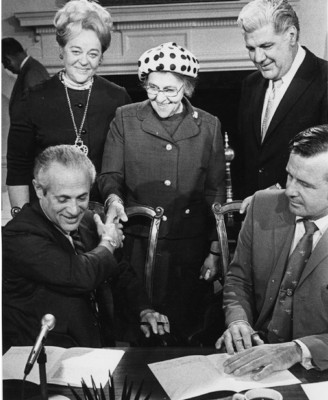 Abrams (standing, left) at the signing of a bill she co-sponsored, c. 1971. Governor Marvin Mandel is seated at left. JMM 1983.8.17.1