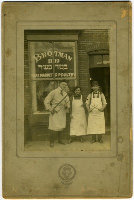 Brotman Meat Market and Poultry, 1119 E. Lombard Street, c. 1923. From left to right: unidentified, Sarah Schneiderman Brotman, and Hyman Brotman. Brotman Meat Market and Poultry was owned by Hyman, Isaac (Itzhak) and Milton Brotman. JMM 2011.47.1