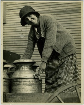 Unidentified woman posing with milk can, c.1924. JMM 1998.47.7.1