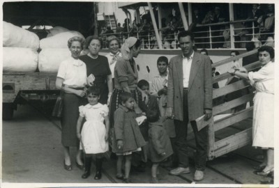 Associated Jewish Charities mission to Israel, the note on the back is dated Nov. 4th, 1954 and reads: ”Darlings, This picture was taken in Haifa on Nov. 1st where we were fortunate enough to see a boat land with over 500 immigrants - mostly Morrocans and a few Egyptians. You can imagine the thrill as each one found his family and friends. Wish you could include this part of the world in your trip - it’s really an eye opener and Bob dear, has real human interest. There are 63 different countries represented here, a real melting pot. Now on to the Neger. Best love, M.”