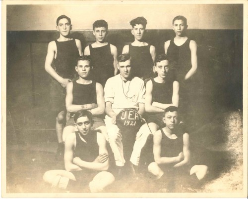 The JEA basketball team posed in the gymnasium, 1921. Jacob Kadish is in the top right. Gift of Shirley Kadish Davids, JMM 2017.1.1