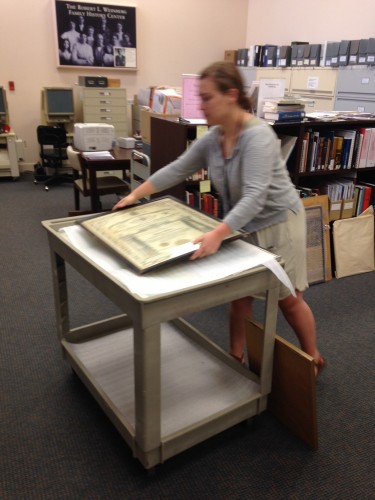 Joelle carefully transporting some of the framed items in our collection after photographing them.