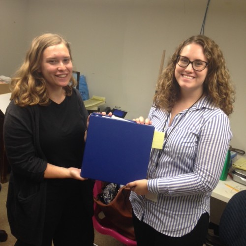 Joelle and Amy with "The Master Binder" - it's heavy!