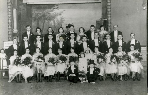 When Rose Friedman married Sam Buckman at Lehmann’s Hall in 1920, the wedding party included 15 ushers, 14 bridesmaids (in a variety of fabrics and dress styles), 2 junior ushers, and 2 flower girls. Gift of Fran Gimbel. JMM 2007.18.1