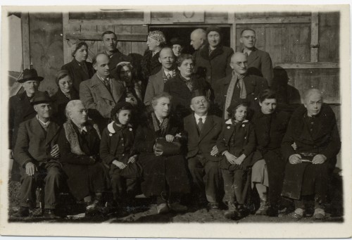 Members of the extended Weil and Wachenheimer families seated outside a barracks at Gurs, an internment camp in the French Pyrenees, 1940. Hilda and Theo Weil are standing in the second row on the right and Lina Wachenheimer is seated, front right. Courtesy of Brenda Mandel, L2002.103.1215.