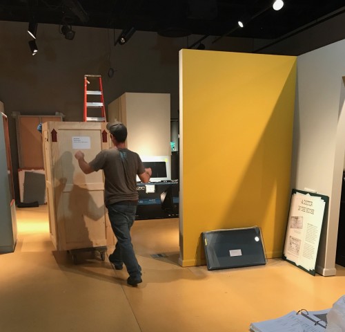 Here, one of their team carefully moves a furniture crate to the “doctor’s office” vignette for unpacking.