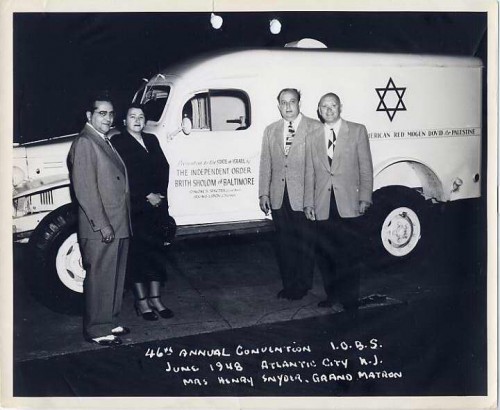 The Independent Order Brith Sholom (IOBS), a fraternal organization formed in 1902 in East Baltimore, was the first fraternal order to buy ambulances for the new state of Israel. It also helped supply money and material for the ship Exodus, helped fund settlement for Yemenite Jewish immigrants, and raised money to build the Brith Sholom of Baltimore Medical Center in Rishon L’Zion. Here, Grand Matron Kay Snyder and three unnamed men stand in front of a truck presented to the new state of Israel during the 46th Annual Convention of IOBS in Atlantic City, June 1948. JMM 1995.209.84.2
