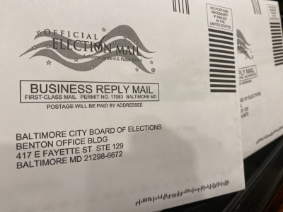 An image of two envelopes addressed to the Baltimore City Board of Elections. A logo indicates that this is "Official Election Mail".