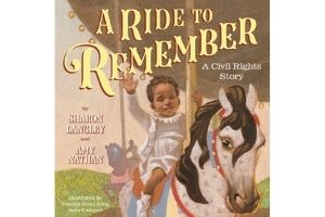 A book cover showing an illustration of a young, black child on a carousel, sitting on one of the horses, waving. The words “A Ride to Remember” are above the child, in yellow text.