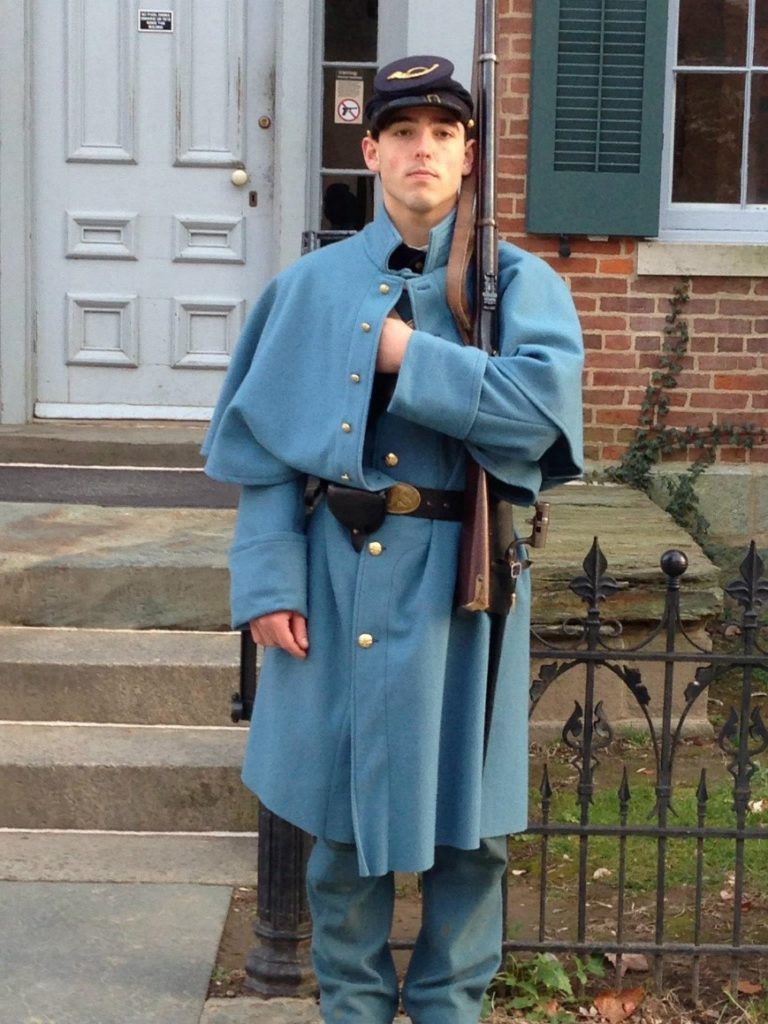 Chris in his re-enactor gear, including a blue woolen overcoat.