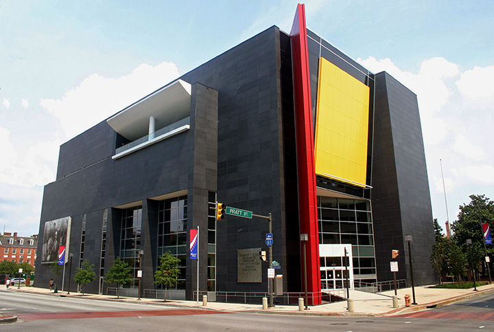 The Reginald F. Lewis Museum, a large, modern and abstract building with yellow and red accent colors.