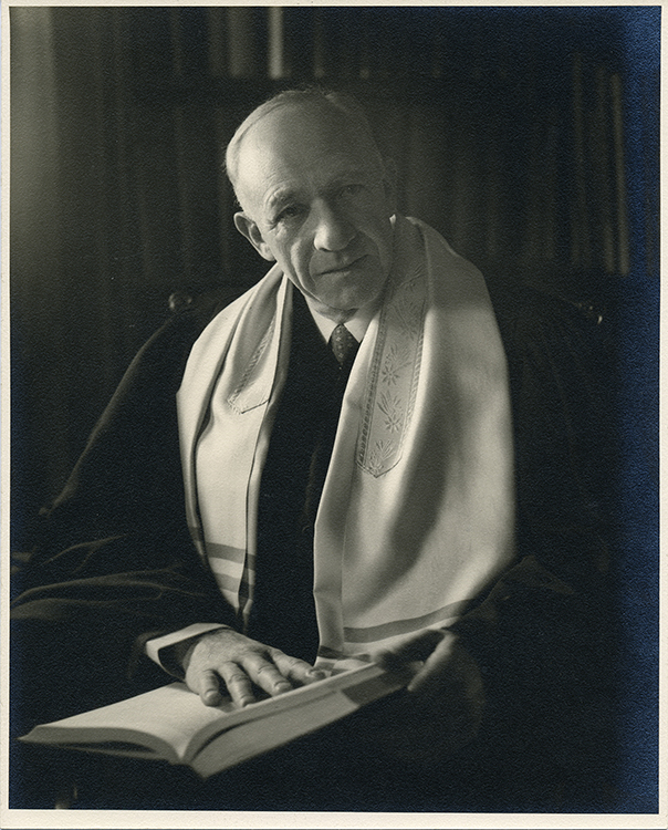 An image of Rabbi Morris Lazaron, wearing a prayer shawl and holding a prayer book.